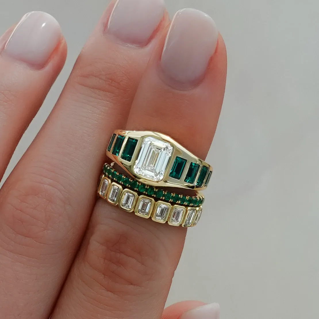 Brick Road Engagement Ring with Green Emeralds and an Emerald Cut